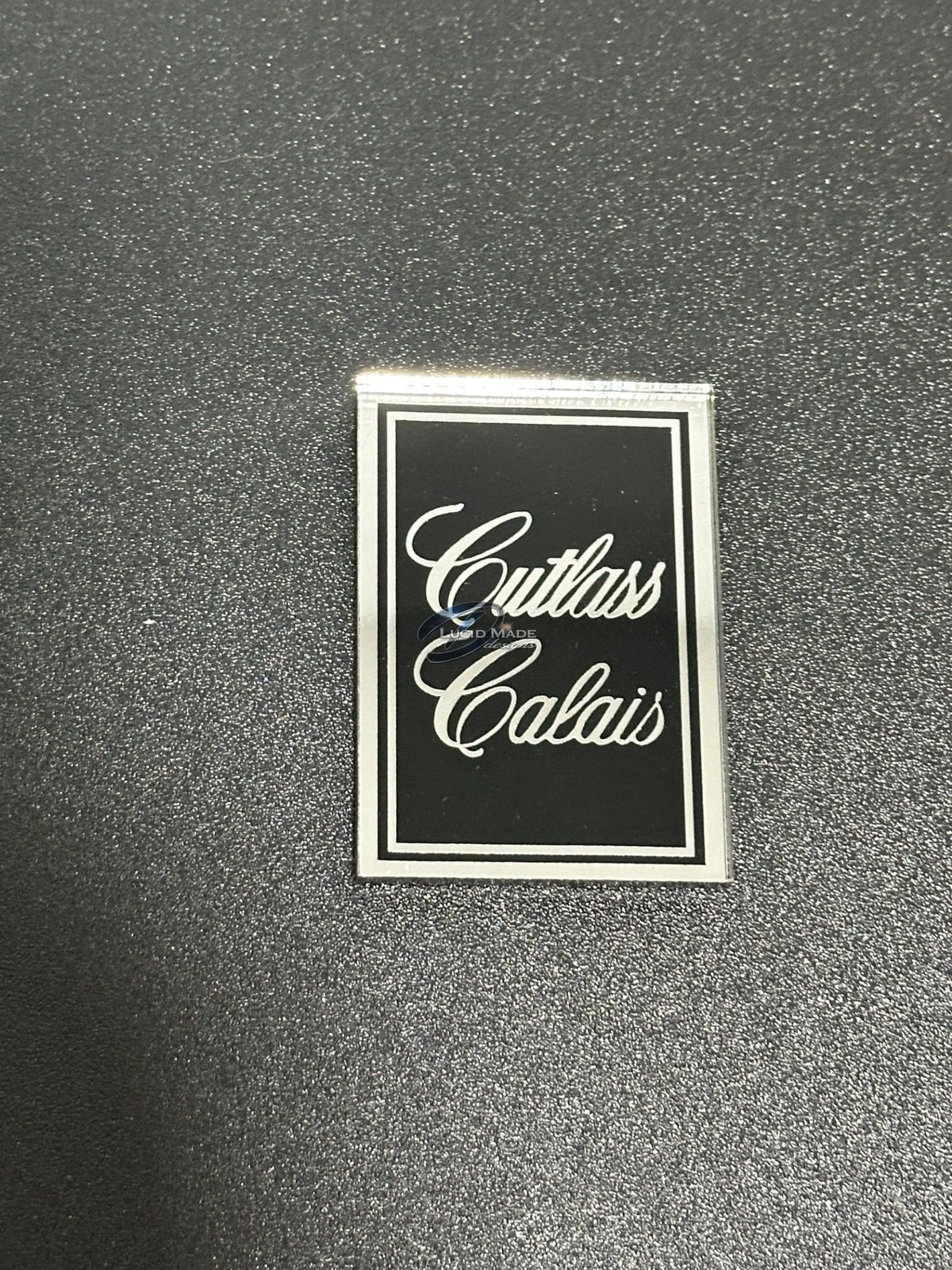 1978 1979 Oldsmobile Cutlass Calais Header Panel Emblem Black and Chrome